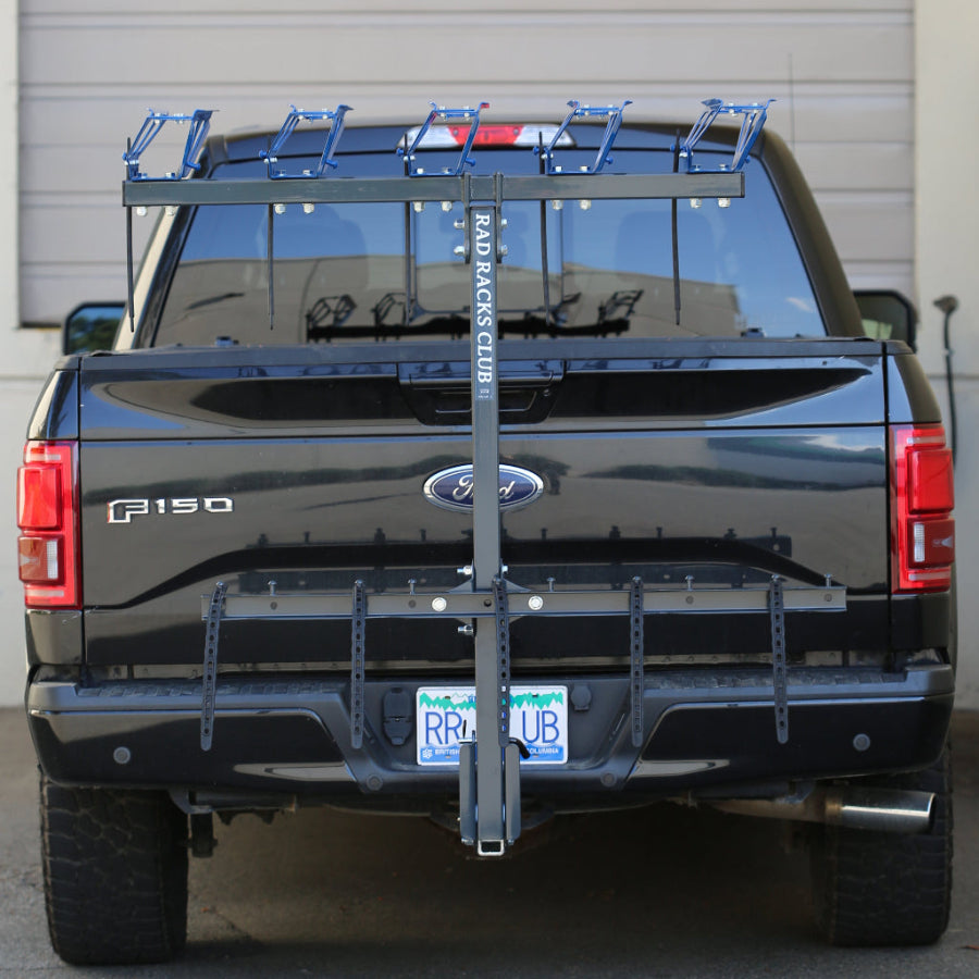 Black Ford F-150 truck with a bike rack on the back