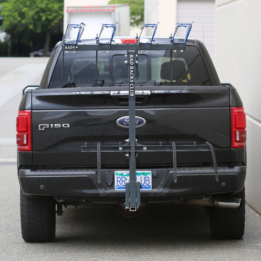 Black truck with a bike rack on a street