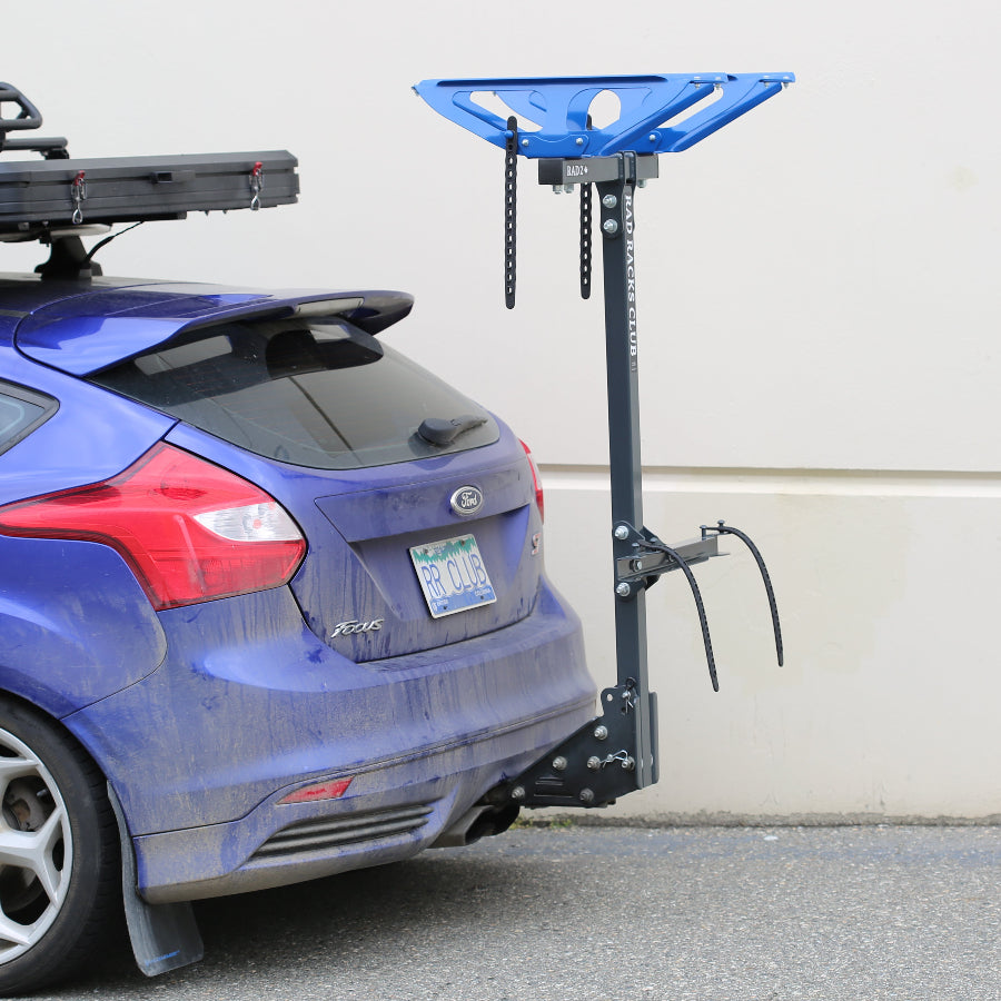 blue car with RAD RACKS CLUB bike rack on vehicle hitch mount