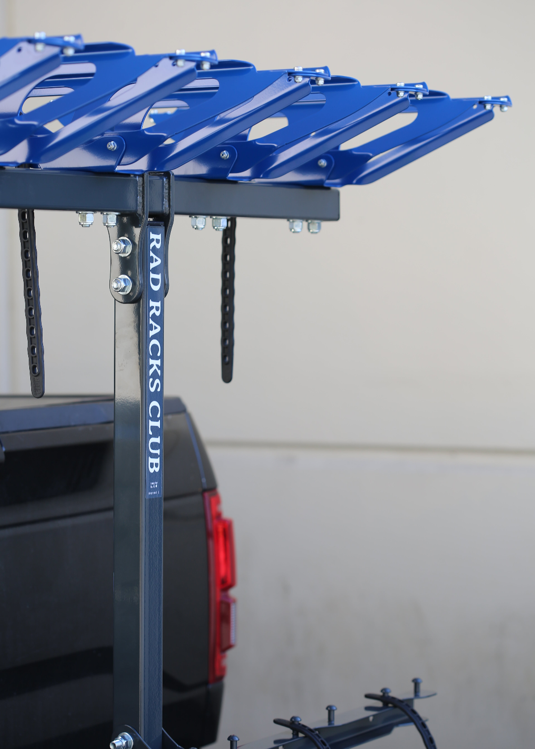 Blue and black metal rack with 'RAD RACKS CLUB' branding on a gray background