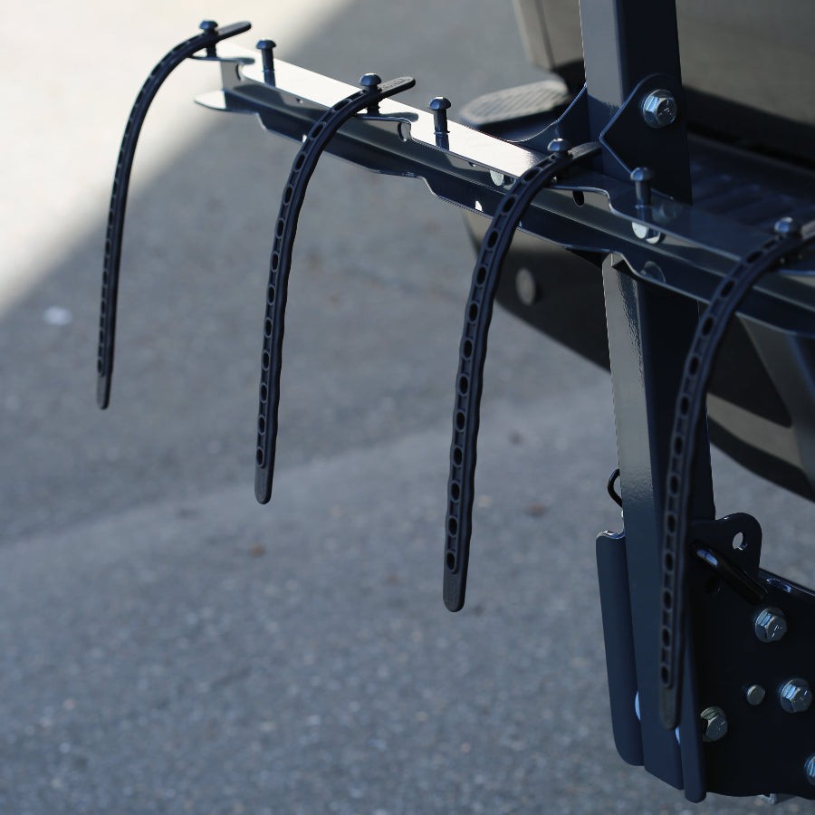 Bicycle rack attached to a vehicle with a blurred background
