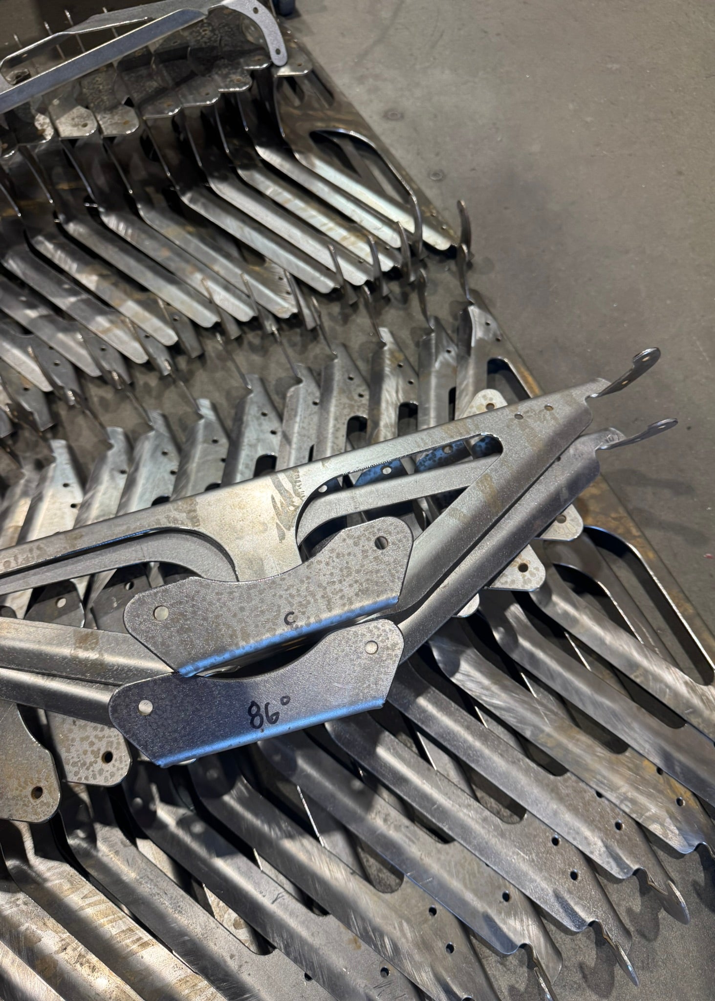 Metallic gear or pulley system with teeth on a gray background