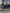 Black Ford truck with a trailer hitch in front of a building with large windows. Built in ramp loading Ebike e bike e-bike on tray bike rack Rad Racks