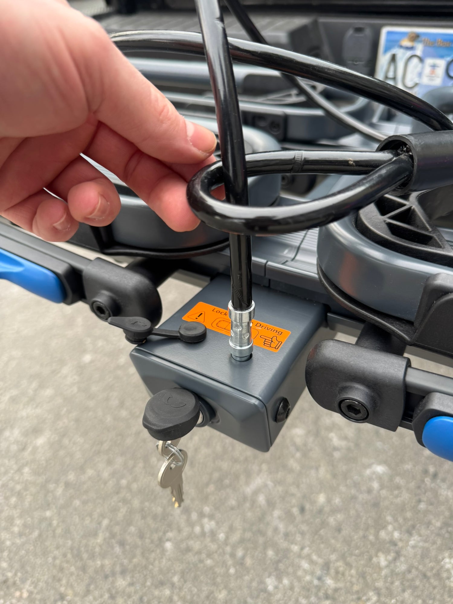 Close-up of a motorcycle lock mechanism with a hand interacting with it. locking cable for bike rack tray bike rack platform rack bicycle security rad racks